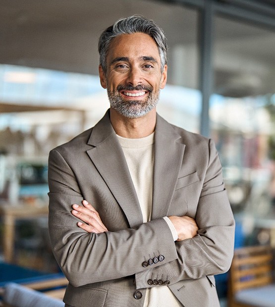 Middle-aged man smiling at work