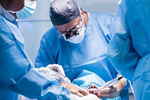 Oral surgeons performing dental implant surgerys