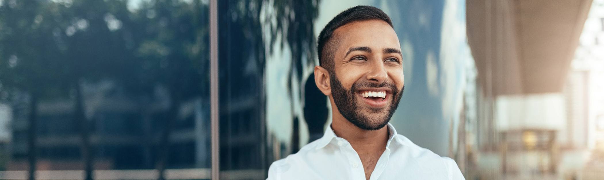 Young man smiling happily after a visit with his UnitedHealthcare dentist in Encino