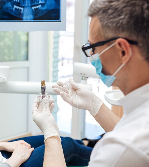 Dentist discussing dental implants with a female patient