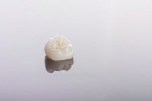 Dental crown on a reflective surface
