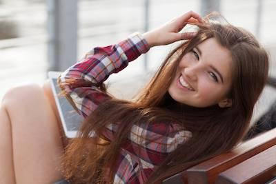 Woman smiling outside holding back her hair, encino ca