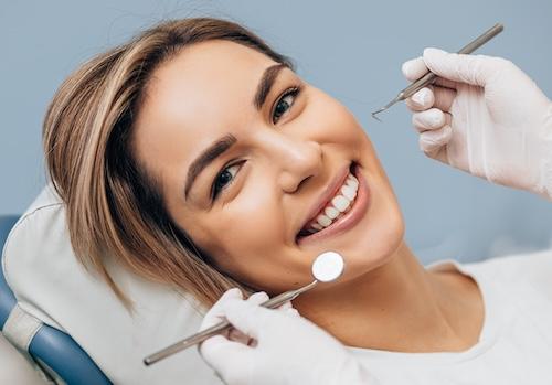 Woman smiling in dentist chair, encino ca