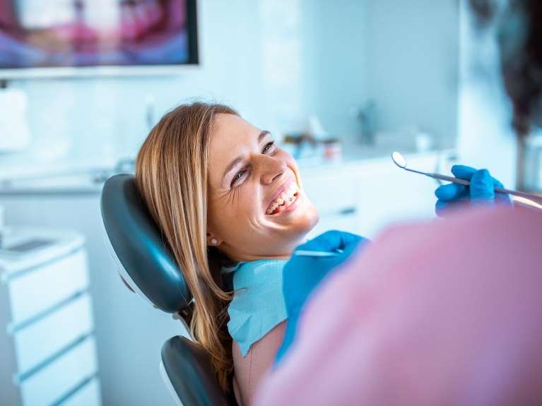 Woman smiling in dental chair, encino ca