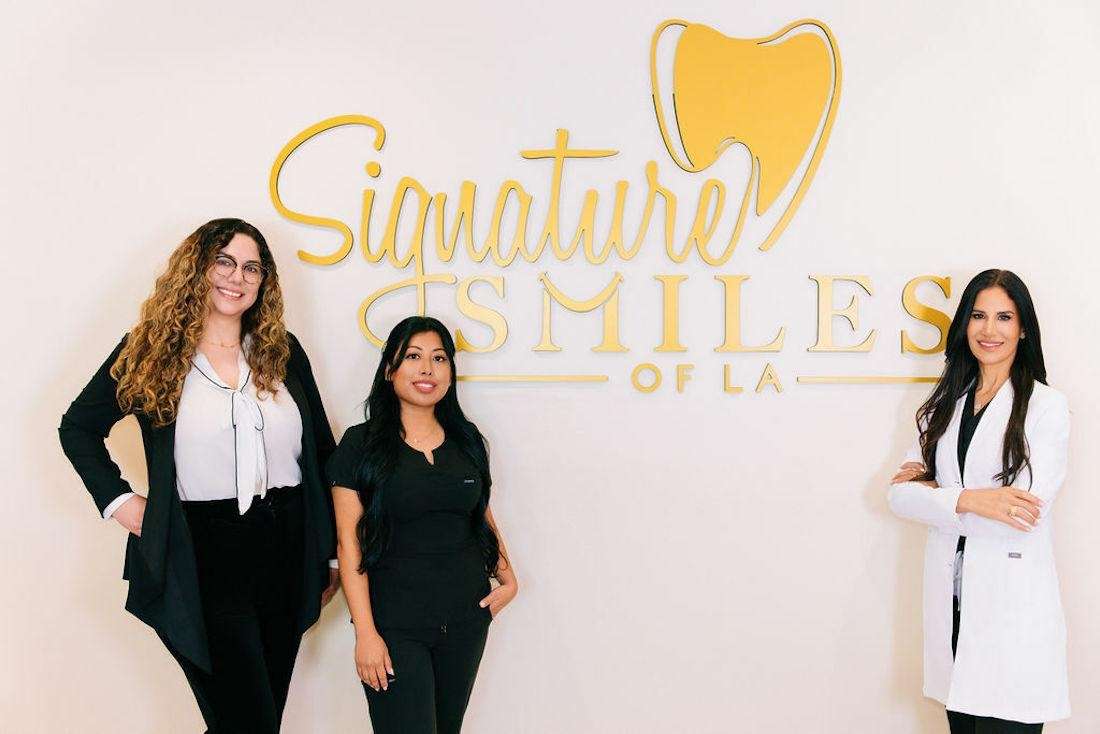 Signature Smiles of LA team standing next to their sign, encino ca