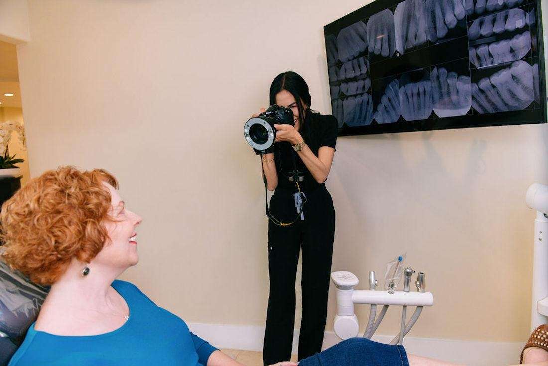 Dr. Mahooti taking patient's photos with x-ray display, encino ca