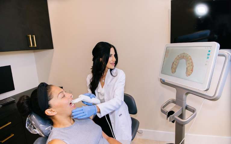 Dr. Mahooti taking digital impressions of a patient, encino ca