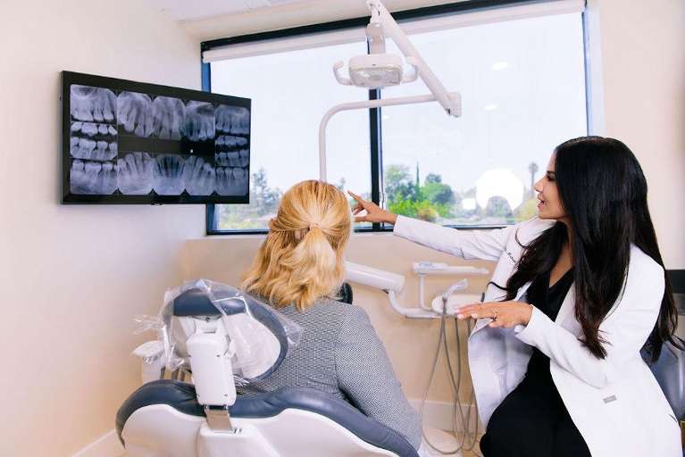 Dr. Mahooti pointing at Digital X-Rays and Sensors at signature smiles of LA, encino ca