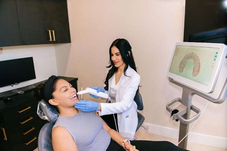 Dr. Mahooti using an intra oral camera on a patient, encino ca